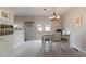 Bright dining room with a wooden table set, a chandelier and sliding glass doors at 6004 Turfway Park Ct, Sugar Hill, GA 30518