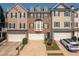 Charming townhome with attached garages, neat landscaping and neutral-colored exterior at 6004 Turfway Park Ct, Sugar Hill, GA 30518