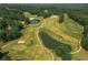 Scenic aerial view of a lush golf course with mature trees, sand traps, and water features creating a picturesque landscape at 6004 Turfway Park Ct, Sugar Hill, GA 30518