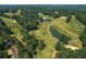 Aerial view of a golf course interspersed with lush greenery and winding paths, accented by tranquil water features at 6004 Turfway Park Ct, Sugar Hill, GA 30518