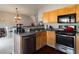 An open kitchen with wood cabinets, stainless steel appliances and a breakfast nook, perfect for modern living at 6004 Turfway Park Ct, Sugar Hill, GA 30518