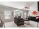Spacious living room with large windows, a bay window, neutral carpet and modern ceiling fan at 6004 Turfway Park Ct, Sugar Hill, GA 30518