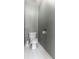 Simple powder room featuring a standard toilet, toilet paper holder, and a neutral paint scheme at 6004 Turfway Park Ct, Sugar Hill, GA 30518