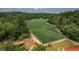 Aerial view of soccer fields bordered by lush trees, a bridge, and pathways at 6004 Turfway Park Ct, Sugar Hill, GA 30518