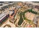 Aerial view of a vibrant town center with a pond, amphitheater, shopping, dining, and landscaped walkways at 6004 Turfway Park Ct, Sugar Hill, GA 30518