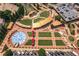 Aerial view of a community town center with an amphitheater, splash pad, green spaces, and outdoor seating areas at 6004 Turfway Park Ct, Sugar Hill, GA 30518