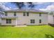 Exterior view of the back of the house with a grassy yard and a patio area at 7190 Cavender Sw Dr, Atlanta, GA 30331