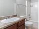 Bathroom features a vanity with dark wood cabinets, granite countertop, and a shower-tub combination at 7190 Cavender Sw Dr, Atlanta, GA 30331