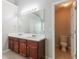 Bathroom features a double sink vanity, neutral walls, and a separate water closet at 7190 Cavender Sw Dr, Atlanta, GA 30331