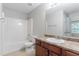 Bathroom featuring a vanity with dark wood cabinets, granite countertop, and a shower-tub combination at 7190 Cavender Sw Dr, Atlanta, GA 30331