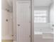 Bathroom featuring a large soaking tub, a separate shower, and neutral tile at 7190 Cavender Sw Dr, Atlanta, GA 30331