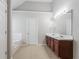 Bathroom features double sinks, neutral walls, a soaking tub, and tiled floors at 7190 Cavender Sw Dr, Atlanta, GA 30331