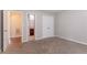 Bedroom with neutral carpet, adjacent bathroom, and closet creating a comfortable, functional layout at 7190 Cavender Sw Dr, Atlanta, GA 30331