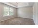 Cozy bedroom with plush carpet, natural light, and a tray ceiling, creating a serene retreat at 7190 Cavender Sw Dr, Atlanta, GA 30331