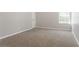 Large Bedroom with a neutral carpet and walls, and a bright window at 7190 Cavender Sw Dr, Atlanta, GA 30331