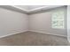 A spacious bedroom with neutral paint, carpet, and natural light from a window at 7190 Cavender Sw Dr, Atlanta, GA 30331