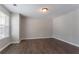This bedroom features hardwood flooring, neutral paint, and lots of natural light at 7190 Cavender Sw Dr, Atlanta, GA 30331
