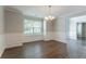 Elegant dining room features chair rail, new flooring, and modern lighting fixture at 7190 Cavender Sw Dr, Atlanta, GA 30331