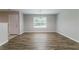 Bright dining area with wood floors, a modern chandelier, and a large window at 7190 Cavender Sw Dr, Atlanta, GA 30331