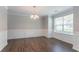 Refreshed dining room boasts chair rail, hardwood flooring and modern light fixture at 7190 Cavender Sw Dr, Atlanta, GA 30331