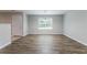 Bright dining area with wood floors, a modern chandelier, and a large window at 7190 Cavender Sw Dr, Atlanta, GA 30331