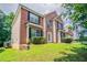 Attractive two-story brick home featuring a well-kept lawn and tasteful landscaping at 7190 Cavender Sw Dr, Atlanta, GA 30331
