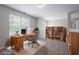 This staged home office has an organized bookshelf and functional desk at 7190 Cavender Sw Dr, Atlanta, GA 30331