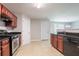 Well-equipped kitchen featuring tile floors, granite countertops, and modern stainless steel appliances at 7190 Cavender Sw Dr, Atlanta, GA 30331