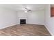 Open living room with a fireplace and wood flooring, offering a cozy and inviting space at 7190 Cavender Sw Dr, Atlanta, GA 30331
