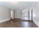 Open living room showcasing the staircase, front door, and beautiful wood flooring at 7190 Cavender Sw Dr, Atlanta, GA 30331