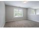 Bright loft area featuring carpet flooring, neutral walls, and natural light from windows at 7190 Cavender Sw Dr, Atlanta, GA 30331