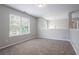 Open loft area showcasing carpet flooring and natural light from window at 7190 Cavender Sw Dr, Atlanta, GA 30331
