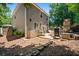 Spacious backyard featuring a patio with grilling area, mature trees, and side yard at 130 Nacoochee Way, Canton, GA 30114