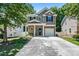 Charming two-story home with a well-maintained yard, covered front porch, and single-car garage at 130 Nacoochee Way, Canton, GA 30114