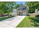 Well-maintained two-story home with a long driveway, green lawn, and classic curb appeal at 130 Nacoochee Way, Canton, GA 30114
