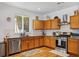 Bright kitchen featuring stainless steel appliances, granite countertops, and wood cabinets at 130 Nacoochee Way, Canton, GA 30114