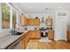 Sun-filled kitchen featuring a stainless steel oven, tile backsplash and granite countertops at 130 Nacoochee Way, Canton, GA 30114