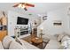 Cozy living room with hardwood floors, a large sectional sofa, and entertainment center with fireplace at 130 Nacoochee Way, Canton, GA 30114