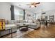 Bright living room featuring a large sectional sofa, hardwood floors, and an open dining area at 130 Nacoochee Way, Canton, GA 30114