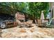 Stone patio featuring an outdoor fireplace, grill, and dining set, perfect for entertaining at 130 Nacoochee Way, Canton, GA 30114