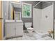 Cozy bathroom featuring a tiled shower, white tiling on the floor, and a window that lets in natural light at 2700 Still Farms Ct, Lawrenceville, GA 30043
