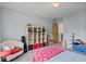 Neutral bedroom with gray walls and carpet; includes seating, and a shelving unit for storage at 2700 Still Farms Ct, Lawrenceville, GA 30043