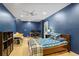 Blue bedroom with carpet, a ceiling fan, a bed, and a door to the exterior at 2700 Still Farms Ct, Lawrenceville, GA 30043
