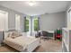 Neutral bedroom with gray walls, carpeted floors, white furniture, and two windows with backyard views at 2700 Still Farms Ct, Lawrenceville, GA 30043