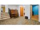 Hallway with beige tiled floor, stairs, piano, and multiple door openings at 2700 Still Farms Ct, Lawrenceville, GA 30043