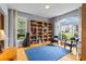 Inviting office space featuring custom bookshelves, hardwood floors, and abundant natural light at 2700 Still Farms Ct, Lawrenceville, GA 30043