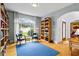 Office space featuring hardwood floors, with custom bookshelves and arched windows with natural light at 2700 Still Farms Ct, Lawrenceville, GA 30043