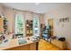 Home office featuring natural light, hardwood floors, a large desk, and custom shelving at 2700 Still Farms Ct, Lawrenceville, GA 30043