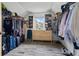 Spacious walk-in closet with wood floors, a window, and storage shelves and clothing racks on both sides at 2700 Still Farms Ct, Lawrenceville, GA 30043