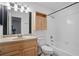 Well-lit bathroom with a tub and shower combination and a wooden vanity at 5157 Roswell Rd # 1, Atlanta, GA 30342